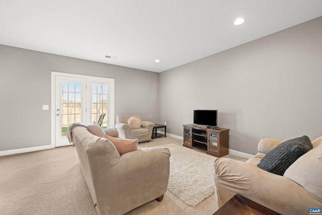 living room with baseboards, light carpet, and recessed lighting