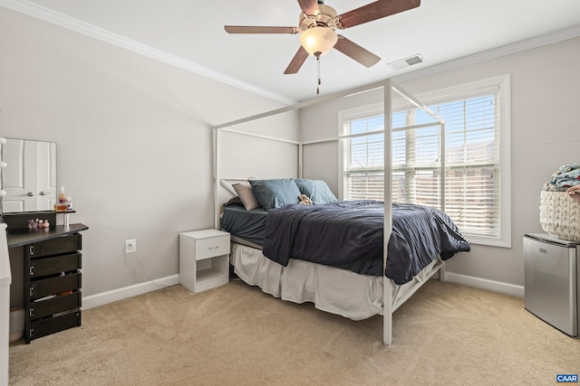 bedroom with crown molding, visible vents, multiple windows, and light carpet