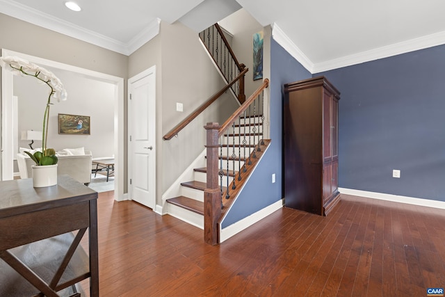 stairway featuring baseboards, ornamental molding, and hardwood / wood-style floors