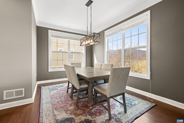 dining area featuring crown molding, baseboards, and visible vents