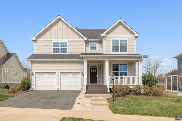 view of front of property featuring board and batten siding, a porch, a garage, and aphalt driveway