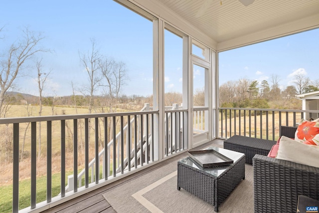 sunroom with a ceiling fan and a healthy amount of sunlight