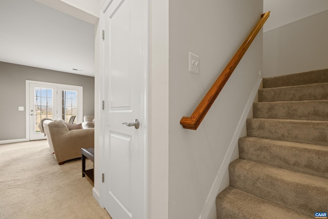 stairs with baseboards and carpet floors