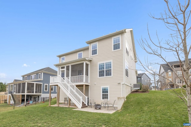 back of house with an outdoor fire pit, stairs, a patio area, and a sunroom