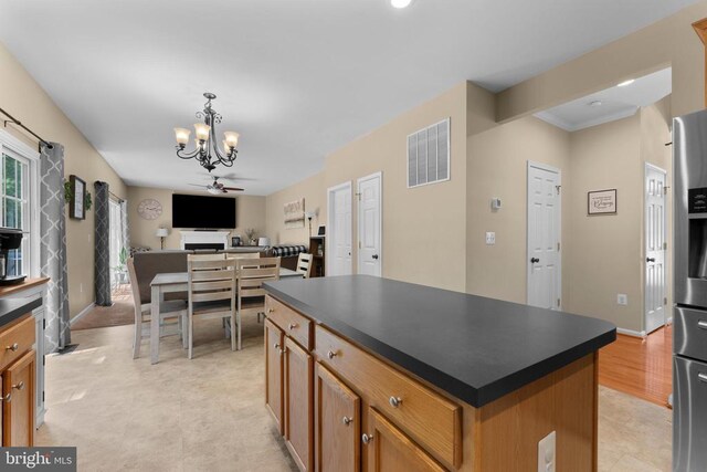 249 Whitworth Dr, Culpeper, VA 22701 - kitchen with a chandelier, dark countertops, a center island, open floor plan, and stainless steel fridge with ice dispenser