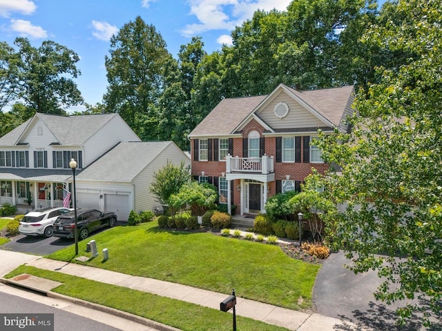 249 Whitworth Dr, Culpeper, VA 22701 - colonial home featuring brick siding, a balcony, a garage, concrete driveway, and a front lawn