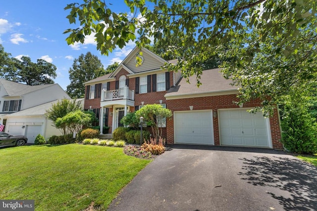 249 Whitworth Dr, Culpeper, VA 22701 - colonial-style house with a balcony, brick siding, a front lawn, asphalt driveway, and a garage