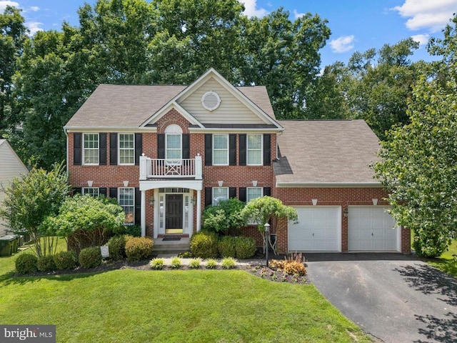 249 Whitworth Dr, Culpeper, VA 22701 - colonial house with a balcony, brick siding, an attached garage, asphalt driveway, and a front lawn