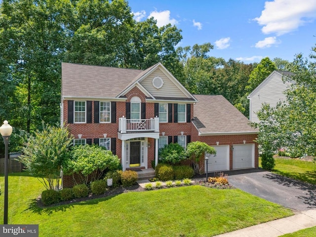 249 Whitworth Dr, Culpeper, VA 22701 - georgian-style home featuring brick siding, an attached garage, asphalt driveway, a front yard, and a shingled roof