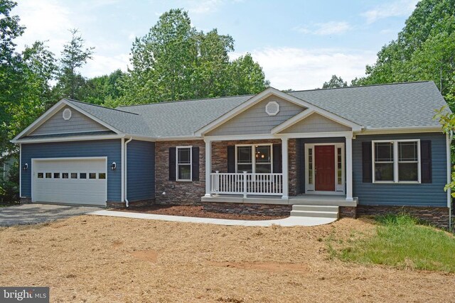 5208 Wyndemere Cir, Mineral, VA 23117 - view of front of house with covered porch, a garage, asphalt driveway, a shingled roof, and stone siding