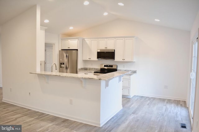 5208 Wyndemere Cir, Mineral, VA 23117 - kitchen featuring stainless steel appliances, a kitchen bar, white cabinetry, vaulted ceiling, and recessed lighting