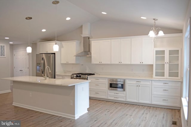 5208 Wyndemere Cir, Mineral, VA 23117 - kitchen featuring stainless steel appliances, white cabinetry, vaulted ceiling, wall chimney range hood, and light wood-type flooring