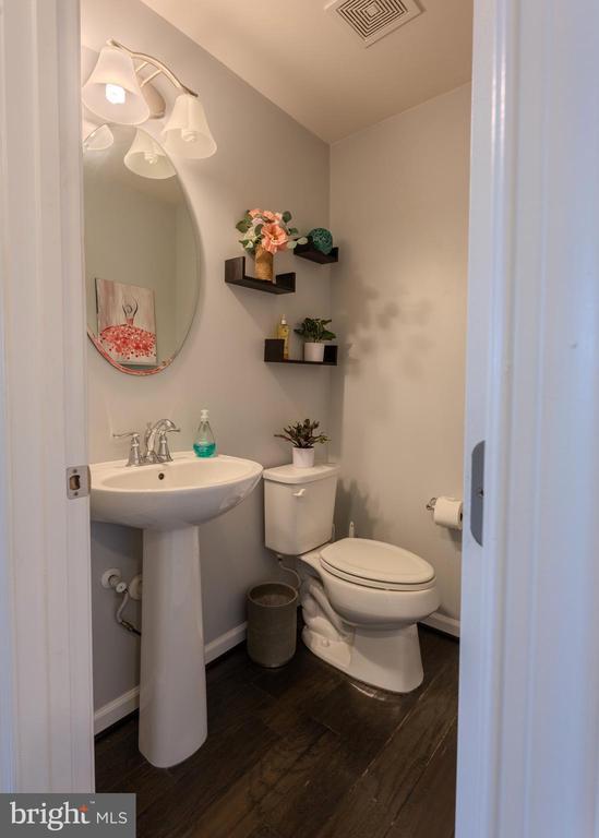 2045 Magnolia Cir, Culpeper, VA 22701 - half bathroom with wood finished floors, toilet, a sink, and baseboards