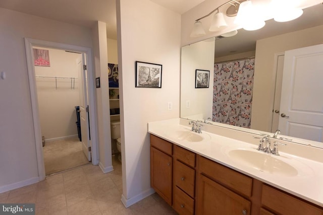 2045 Magnolia Cir, Culpeper, VA 22701 - full bathroom with double vanity, toilet, baseboards, and a spacious closet