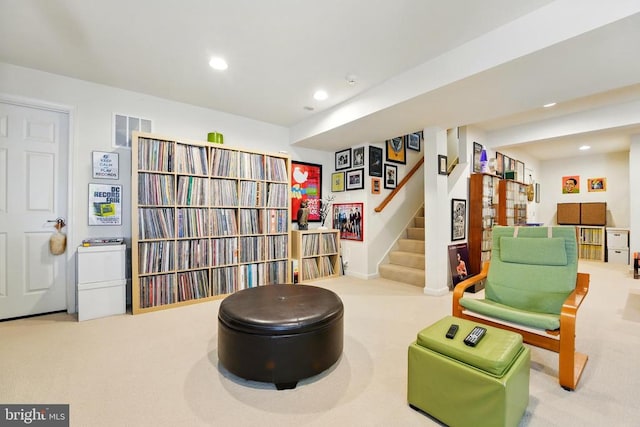 sitting room featuring carpet, stairway, and recessed lighting