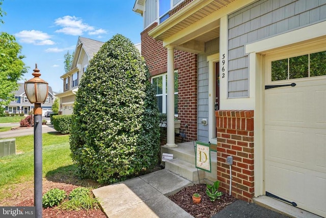 entrance to property featuring brick siding