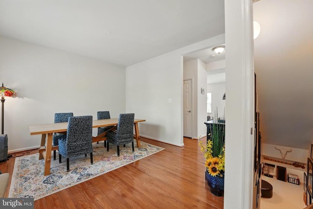 dining space with wood finished floors and baseboards
