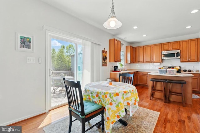 dining area with light wood-style flooring and recessed lighting
