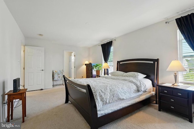 bedroom featuring light carpet