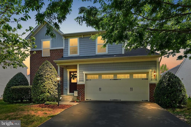 view of front facade featuring brick siding, asphalt driveway, board and batten siding, and an attached garage