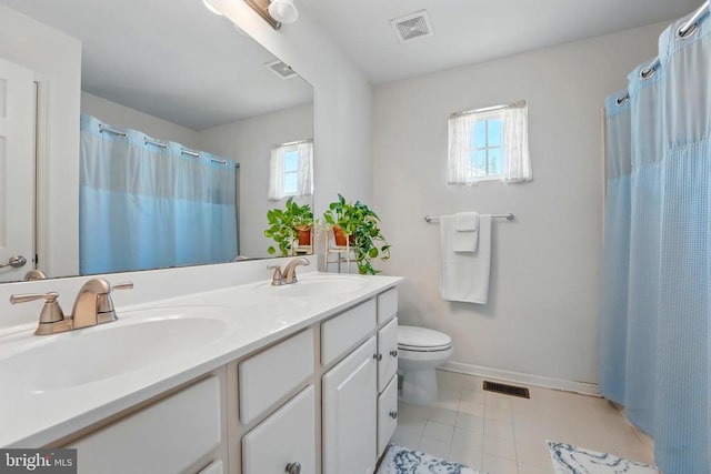 full bathroom featuring toilet, double vanity, tile patterned floors, baseboards, and a shower with shower curtain