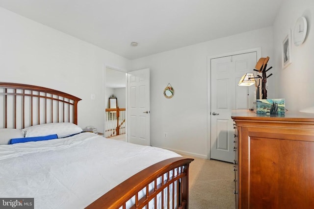 bedroom featuring light colored carpet and baseboards