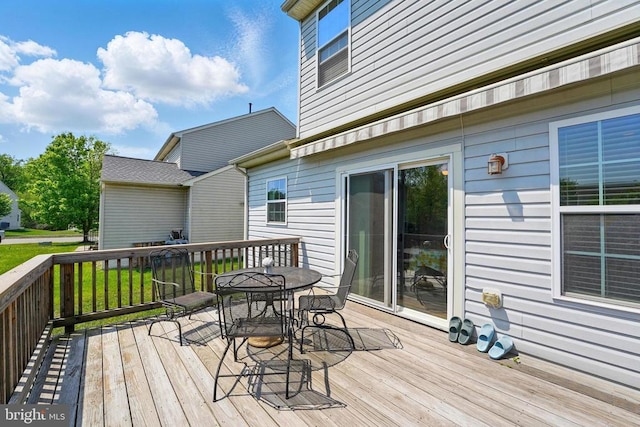 wooden terrace featuring outdoor dining space