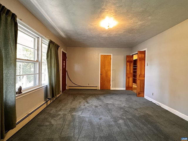 unfurnished bedroom featuring a baseboard heating unit, a textured ceiling, a baseboard radiator, carpet flooring, and baseboards