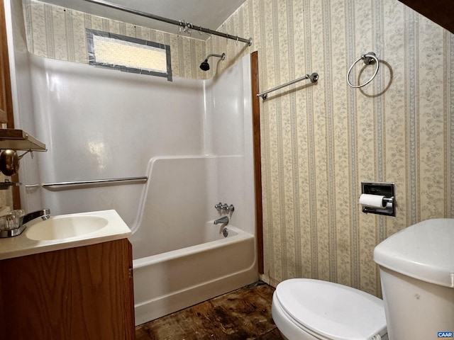 bathroom featuring toilet, bathing tub / shower combination, vanity, and wallpapered walls
