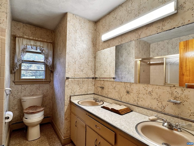 bathroom with a sink, double vanity, toilet, and a stall shower