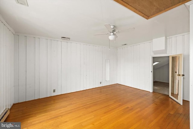 2188 Seville Rd, Madison, VA 22727 - empty room featuring wood finished floors, a ceiling fan, baseboard heating, and crown molding
