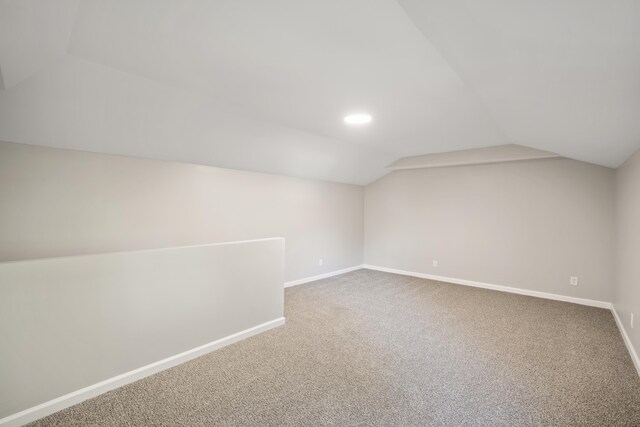 bonus room featuring lofted ceiling and carpet