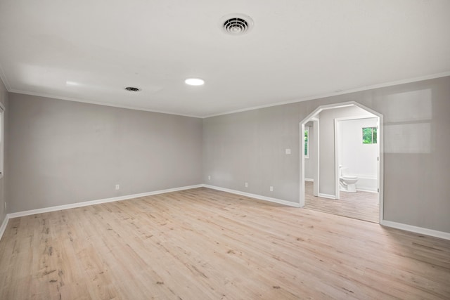 unfurnished room featuring crown molding and light hardwood / wood-style flooring