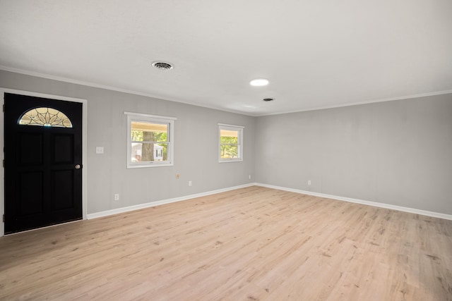 entrance foyer featuring crown molding and light hardwood / wood-style flooring