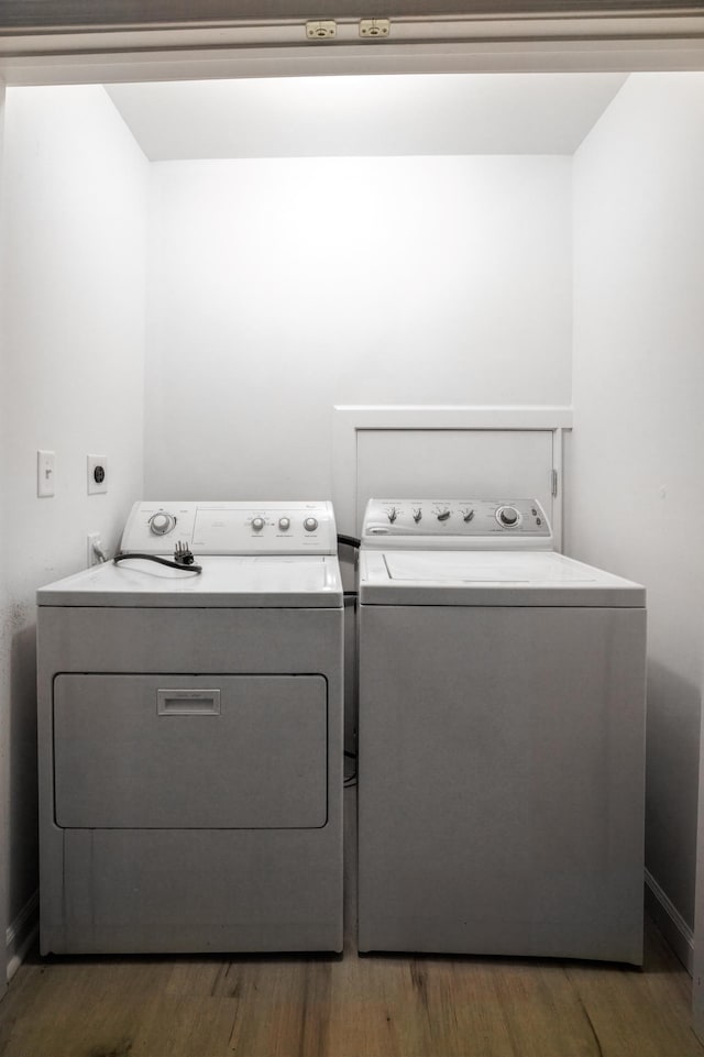 laundry room with washing machine and dryer and dark hardwood / wood-style floors