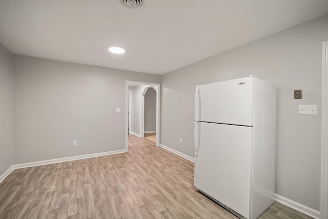 kitchen with white fridge and light hardwood / wood-style flooring