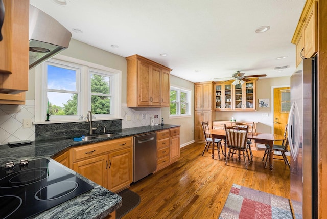 3226 Old Thirty Three Rd, Rockingham, VA 22801 - kitchen with appliances with stainless steel finishes, a sink, light wood-style floors, tasteful backsplash, and brown cabinets