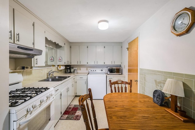 3226 Old Thirty Three Rd, Rockingham, VA 22801 - kitchen featuring washer / clothes dryer, under cabinet range hood, white range with gas cooktop, a sink, and stainless steel microwave