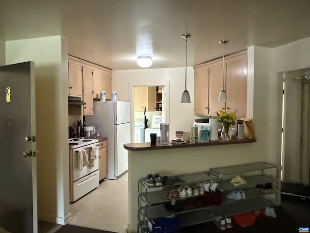 2108 Jefferson Park Ave, Charlottesville, VA 22903 - kitchen featuring white appliances, under cabinet range hood, washer and clothes dryer, decorative light fixtures, and a peninsula