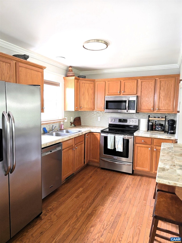 1060 E River Rd, Palmyra, VA 23055 - kitchen featuring appliances with stainless steel finishes, crown molding, a sink, light countertops, and hardwood / wood-style flooring