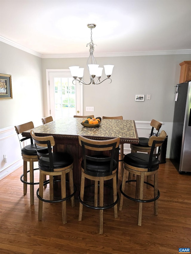 1060 E River Rd, Palmyra, VA 23055 - dining space with a chandelier, dark wood-style flooring, crown molding, and a wainscoted wall