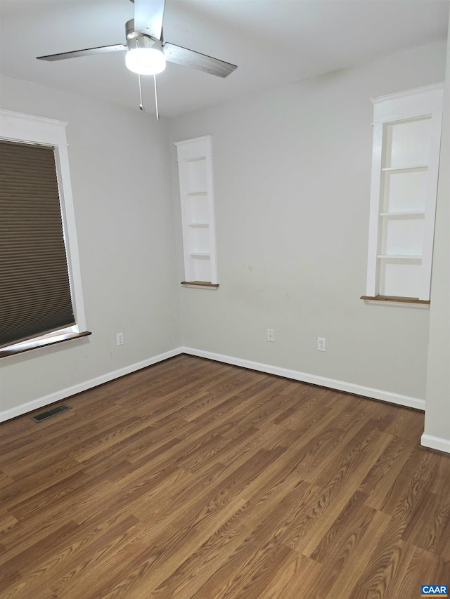 1060 E River Rd, Palmyra, VA 23055 - spare room featuring wood finished floors, a ceiling fan, and built in shelves