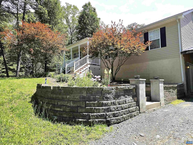 1060 E River Rd, Palmyra, VA 23055 - view of front of property featuring covered porch, a front yard, and stairs