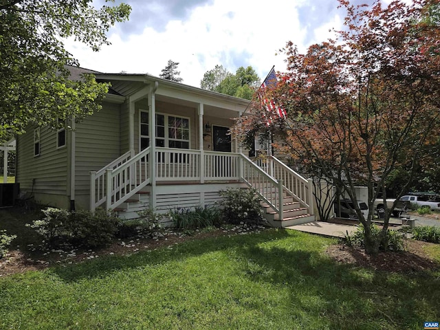 1060 E River Rd, Palmyra, VA 23055 - view of front of house with covered porch, a front yard, and stairs