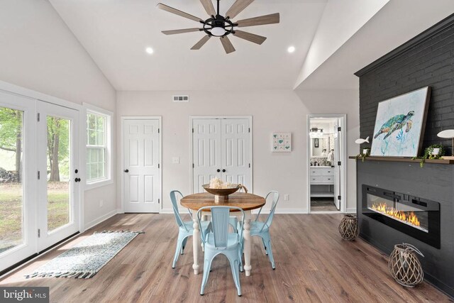 121 Birchside Cir, Locust Grove, VA 22508 - dining area with high vaulted ceiling, a ceiling fan, wood finished floors, recessed lighting, and a glass covered fireplace