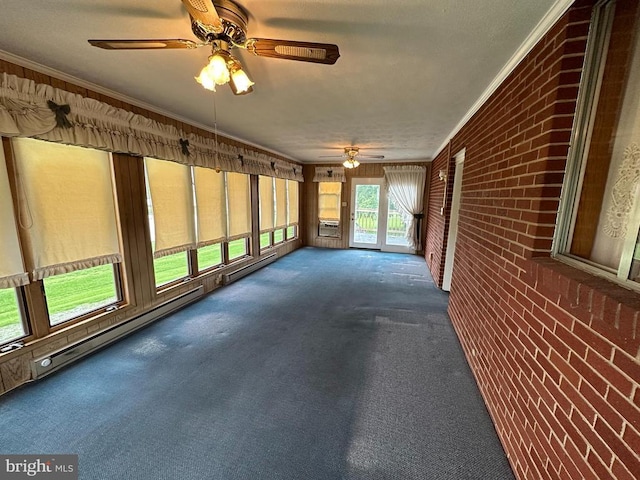 unfurnished sunroom featuring brick wall, ceiling fan, carpet, and ornamental molding