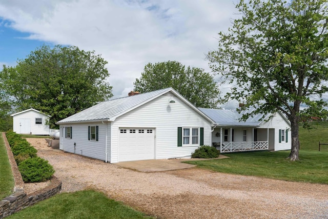 ranch-style house featuring driveway, a porch, a garage, metal roof, and a chimney