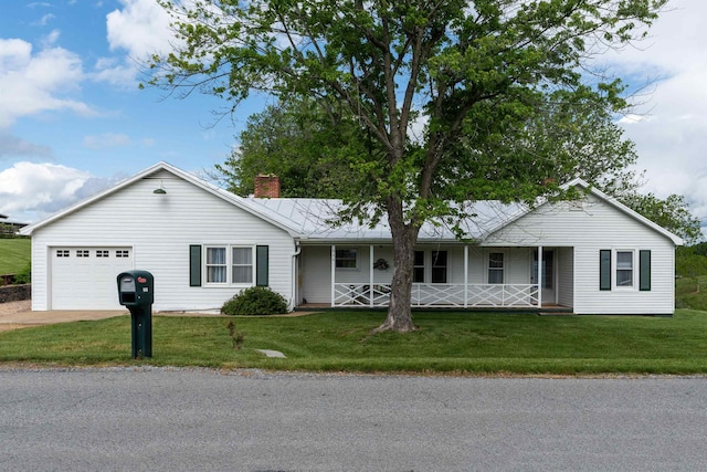 ranch-style house with covered porch, a front yard, a chimney, and an attached garage