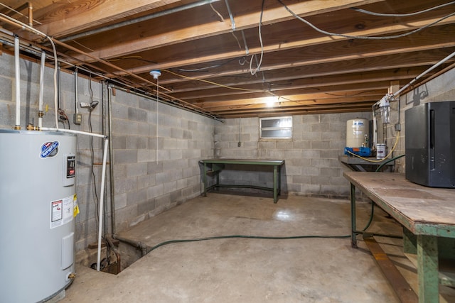 unfinished basement featuring water heater and a water pressure tank