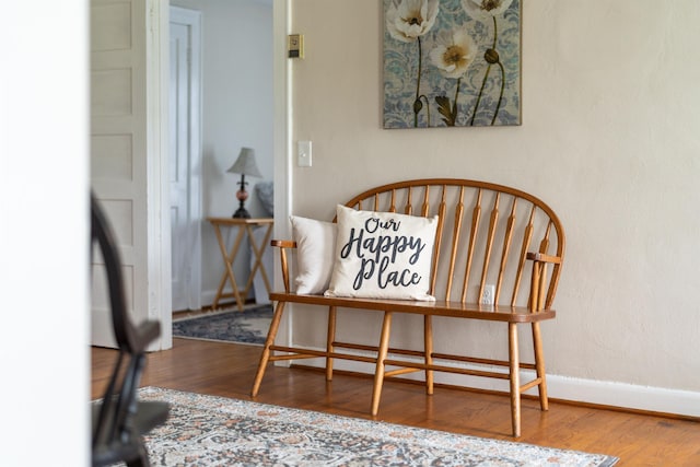 living area with wood finished floors and baseboards